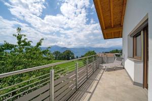 a balcony with a chair and a view of the mountains at Villa Reny in Meltina