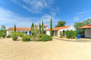 a house with trees in front of a yard at Canto do Sol - Selão da Eira in Pedreneiras