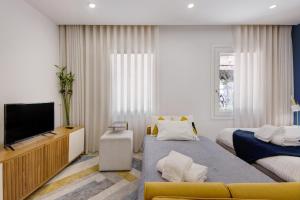 a hotel room with two beds and a flat screen tv at Aveiro City Blue in Aveiro