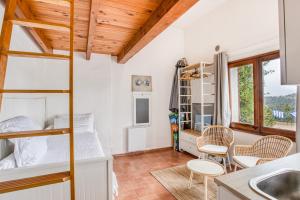 a bedroom with a bunk bed and a kitchen at Casa Mathilda in Calonge +28 photos
