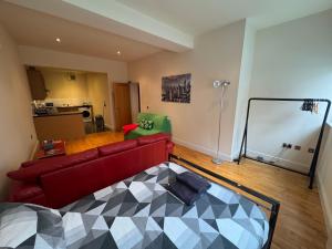 a living room with a red couch and a table at Cardiff City Escapes in Cardiff