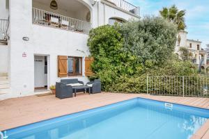 a house with a swimming pool in front of a building at Casa Mathilda in Calonge