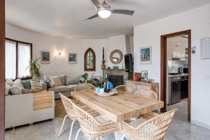 a living room with a wooden table and chairs at Casa Mathilda in Calonge