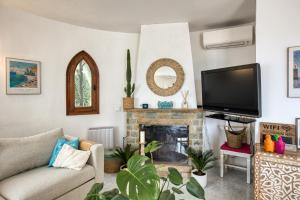 a living room with a tv and a fireplace at Casa Mathilda in Calonge