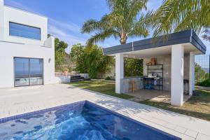 a house with a swimming pool in front of a house at Villa Palacio Nazari in Málaga