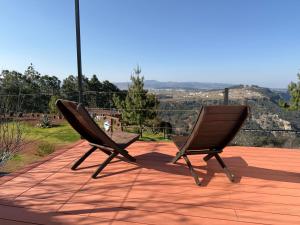 two chairs sitting on top of a patio at Glamping Las Nubes in Chignahuapan