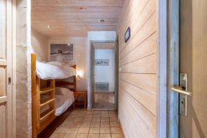 a small room with a bunk bed and a hallway at Appartement Flocon in Champagny-en-Vanoise