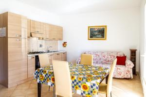 a kitchen and dining room with a table and chairs at Terra in Follonica +14 photos