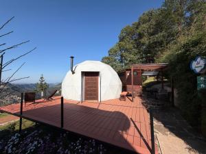 a large white dome tent with a deck at Glamping Las Nubes in Chignahuapan