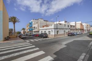 a city street with cars parked on the side of the road at Casa Us in Arinaga