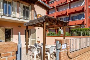 a patio with a table and chairs in front of a building at Terra in Follonica