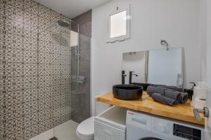 a bathroom with a sink and a shower at Casa Us in Arinaga +22 photos