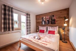 a bedroom with a large bed with red pillows at Apartment Eve in Söll