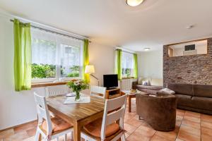 a living room with a table and a couch at im Oberdorf in Achern