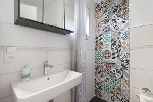 a bathroom with a sink and a shower at Kompass Oase in Burg +18 photos