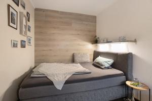 a small bedroom with a bed with a wooden headboard at Kompass Oase in Burg