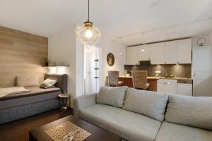 a living room with a couch and a kitchen at Kompass Oase in Burg