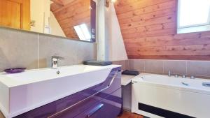 a bathroom with a white sink and a tub at Albert Ranch House - Grande maison au calme - Parking in Ribeauvillé +65 photos