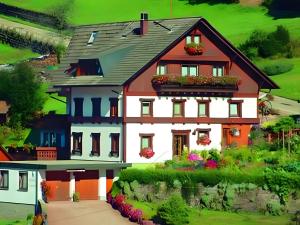 a house with flowers in front of it at Gästehaus Heimenberg in Bad Rippoldsau-Schapbach