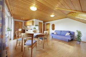 a kitchen and living room with a table and chairs at Winzerhof Wörner in Durbach