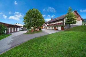 an empty road leading to a building with a tree at Winzerhof Wörner in Durbach