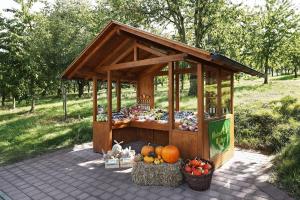 a fruit and vegetable stand with pumpkins and hay at Winzerhof Wörner in Durbach +4 photos
