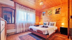a bedroom with a bed in a wooden room at Albert Ranch House - Grande maison au calme - Parking in Ribeauvillé