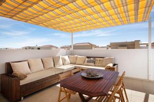 a living room with a couch and a table at Oramas Beach House – Pool & Terrace in Puertito de Güímar