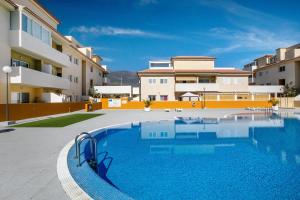 a swimming pool in front of a building at Oramas Beach House – Pool & Terrace in Puertito de Güímar
