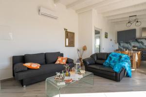 a living room with a couch and a table at Moon - Rooms in Quartu SantʼElena