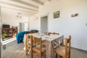 a dining room and living room with a table and chairs at Moon - Rooms in Quartu SantʼElena