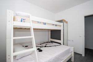 a bedroom with two bunk beds with white walls at Apartamento Marei 1 in Cala Blanca +25 photos