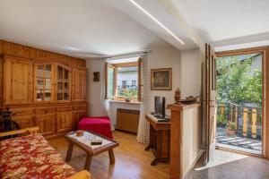 a living room with a couch and a tv at Il Borgo - Aymavilles in Aymavilles