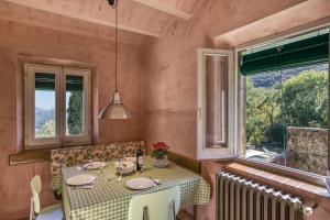 a dining room with a table and a window at La Rectoría de Castellar in La Vall de Bianya
