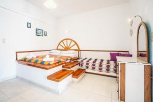 a bedroom with two beds and a sink at Panorama Tilos Apt A in Tílos