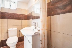 a bathroom with a toilet and a sink at Panorama Tilos Apt A in Tílos