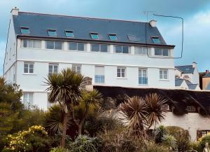 a large white building with a lot of windows at Appartement duplex vue mer in Audierne