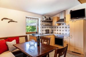 a kitchen with a table and a dining room at Haus Auner Top 4 in Westendorf +17 photos
