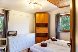 a bedroom with two beds and a cabinet at Haus Auner Top 4 in Westendorf