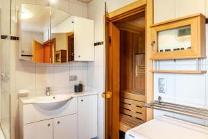 a bathroom with a sink and a mirror at Haus Auner Top 4 in Westendorf