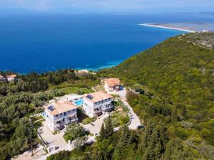 an aerial view of a house on a hill next to the ocean at Superior Apartment A in Tsoukalades