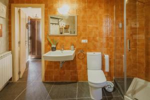 a bathroom with a toilet and a sink at Astial Ezquerra - Casa Rural in Ezquerra +28 photos