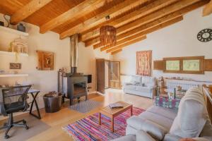 a living room with a couch and a fireplace at Astial Ezquerra - Casa Rural in Ezquerra