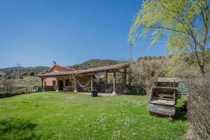 a house with a grill in front of a yard at Astial Ezquerra - Casa Rural in Ezquerra