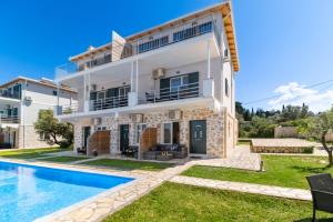 an image of a villa with a swimming pool at Superior Apartment A in Tsoukalades