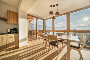 a kitchen and dining room with a table and chairs at Apt Zirbe - Nockerhof in Andrian