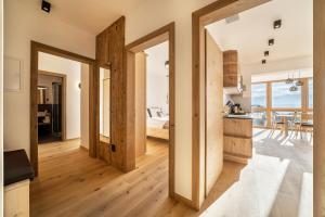 a kitchen and living room with a view of a bedroom at Apt Zirbe - Nockerhof in Andrian