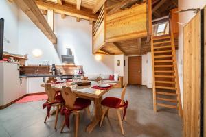 a kitchen and dining room with a table and chairs at Ferienhaus Larch Soge Apt Paula in Racines