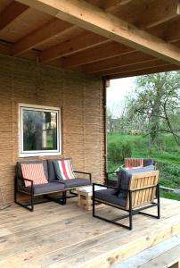 a patio with two couches on a wooden deck at Das Sommerhaus in Zülow