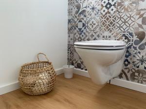 a bathroom with a toilet and a basket at Das Sommerhaus in Zülow +11 photos